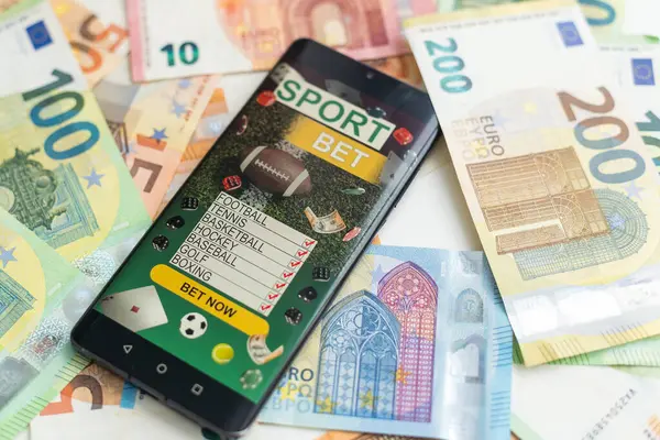 Dollar Und Euro Smartphone Mit Sportwetten Anwendung Hochwertiges Foto lizenzfreie Stockfotos