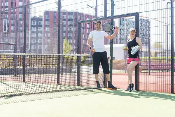 stock image  young woman playing Padel Tennis with partner in the open air tennis court. High quality photo