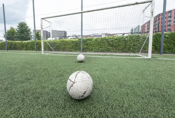 stock image Green grass and white border lines on football ground. Soccer field on artificial turf. Artificial green grass texture. Artificial football field in an open stadium. High quality photo