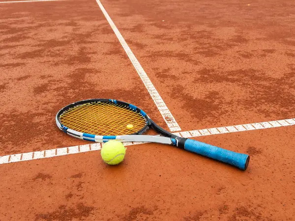 stock image tennis racket with a tennis ball on a tennis court. High quality photo