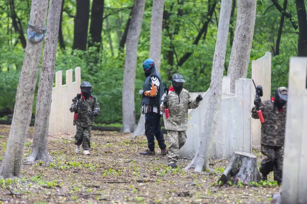 stock image children playing paintball in the forest. High quality photo