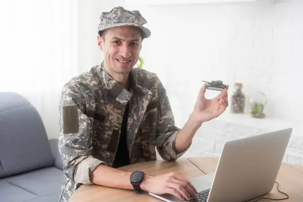 stock image military man holding a model tank. High quality photo