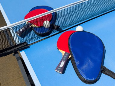 Mavi bir masada pinpon oynamak için iki raket. Yüksek kalite fotoğraf