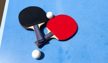 Mavi bir masada pinpon oynamak için iki raket. Yüksek kalite fotoğraf