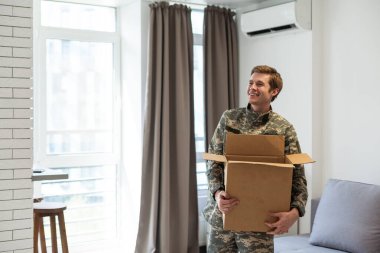 military man holding a box. clipart