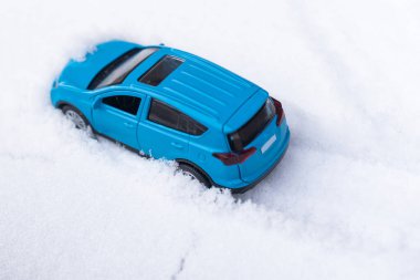 toy car riding by snow background.