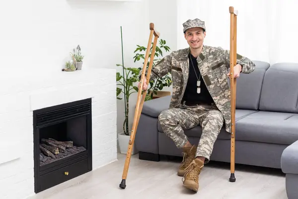 stock image military man with crutches, disability.