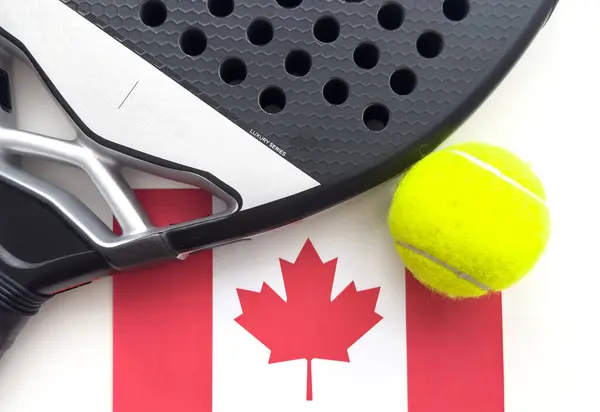 stock image padel racket with ball and flag of Canada on white background. High quality photo