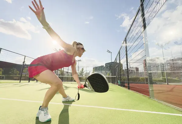 stock image European young woman tennis player in padel tennis playing during a friendly doubles match on the outdoor court. High quality photo