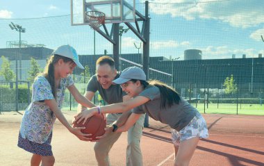 Baba ve genç kızlar sarayda basketbol oynuyorlar. Yüksek kalite fotoğraf