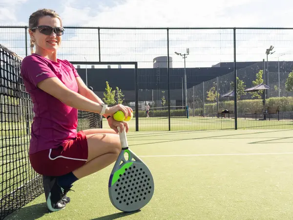 stock image Happy female paddle tennis player during practice on outdoor court looking at camera. Copy space. High quality photo