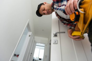 Man removing lock from door . High quality photo clipart