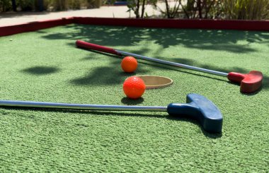 Closeup of player play mini golf with ball. High quality photo clipart