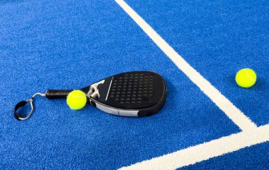 Padel raketi mavi bir kortta top ile. Yüksek kalite fotoğraf