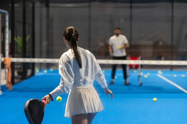  Genç kızlar yüksek kaliteli bir fotoğrafta Padel oynuyor.