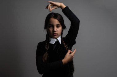 A girl with braids in a gothic style on a dark background clipart