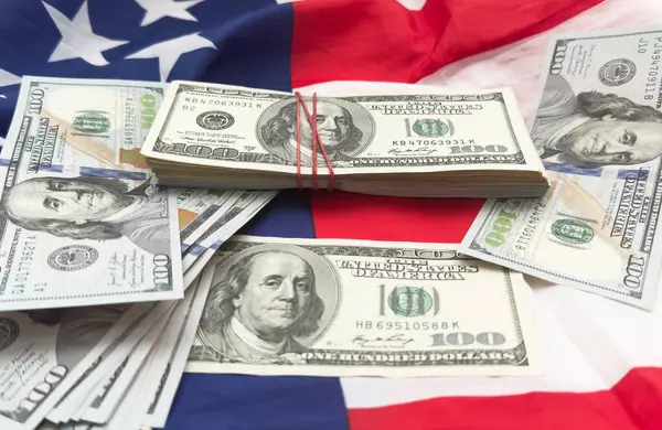 Stock image One hundred dollars banknotes on flag background. High quality photo