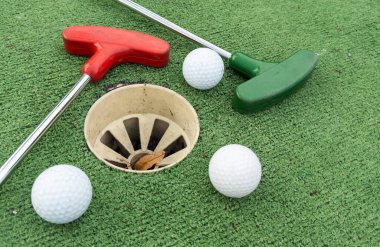 Mini golf close-up, colorful golf putters, balls. High quality photo clipart