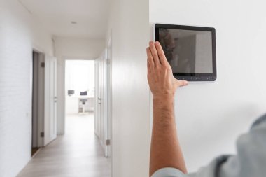 Genç elektrikçi duvara güvenlik alarmı kuruyor. Yüksek kalite fotoğraf