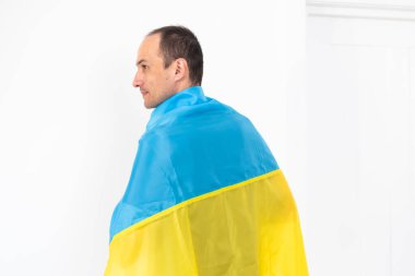 Young man holding Ukraine Flag in White Background. High quality photo
