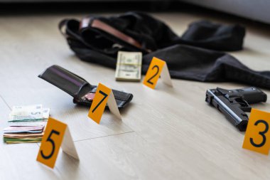 Olay yeri inceleme, dairedeki cinayetten sonra kanıtların numaralandırılması. Pirinç muşta, cüzdan ve üzerinde kanıt işaretleri olan kıyafetler. Yüksek kalite fotoğraf