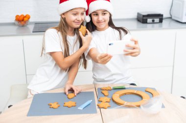 Çocuklar mutfakta Noel kurabiyeleri süslüyor. Yüksek kalite fotoğraf
