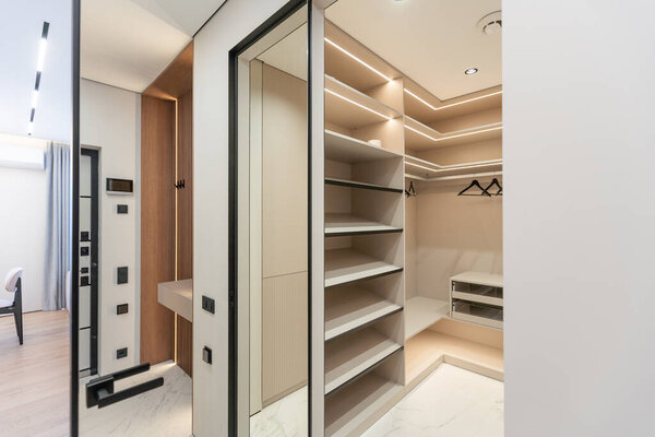 Modern interior, beautiful wardrobe without clothes. Empty wardrobe room with opened shelves. Walk in closet interior concept . High quality photo