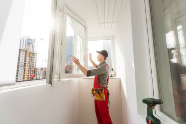 The worker installing and checking window in the house. High quality photo