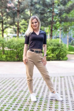 Binanın yanında duran genç, sevimli sarışın. Yüksek kalite fotoğraf