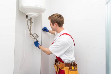Professional engineer doing a boiler inspection at home.