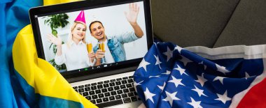 laptop near the usa and ukraine flag. clipart