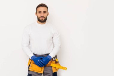Male worker in a uniform posing isolated on white background.