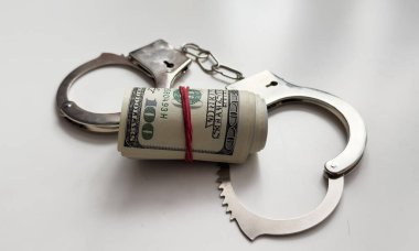 Money and handcuffs isolated on white background. High quality photo clipart