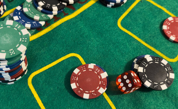 poker chips and cards on the green table background . High quality photo