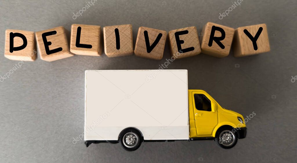 Toy truck and cubes with words FREE DELIVERY isolated on white. Logistics and wholesale concept. High quality photo