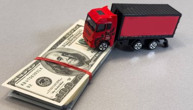  Oyuncak kamyon dolar üzerine yalan söylüyor, mesaj için yer var. Yüksek kalite fotoğraf