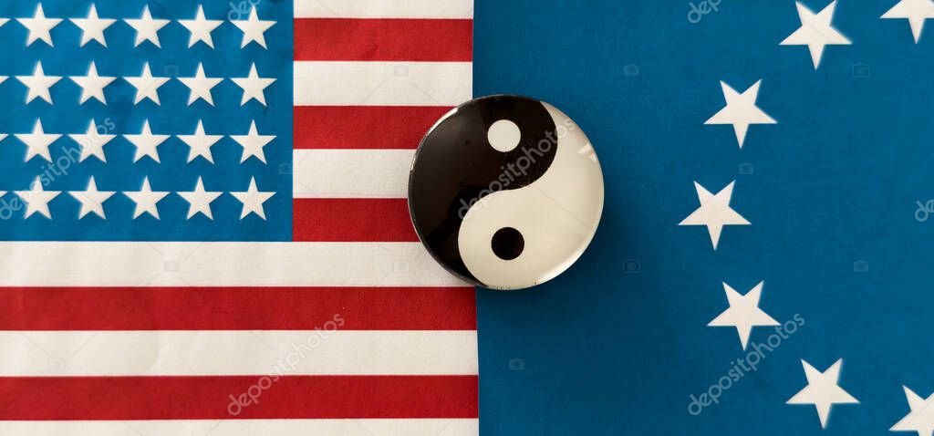 Yin and yang figurine on the background of the flags. High quality photo