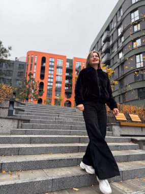 Kış kıyafetiyle sokakta yürüyen şık, çekici, genç bir kadın. Mutlu bir ruh hali, moda modası. Yüksek kalite fotoğraf