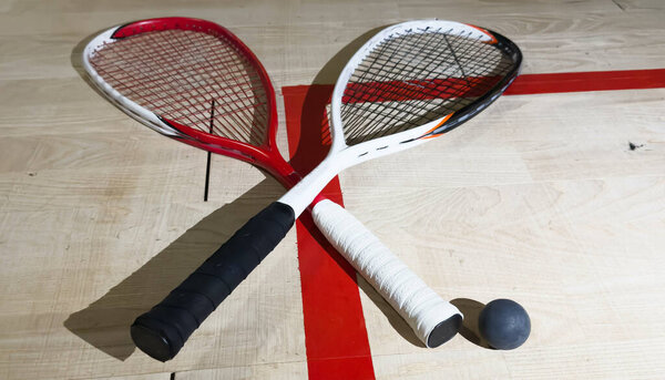 Sports, above and racket on squash court for competition, challenge and training center. Exercise, interior and empty room with top view of wooden floor of gymnasium for games, fitness club and gear. High quality photo