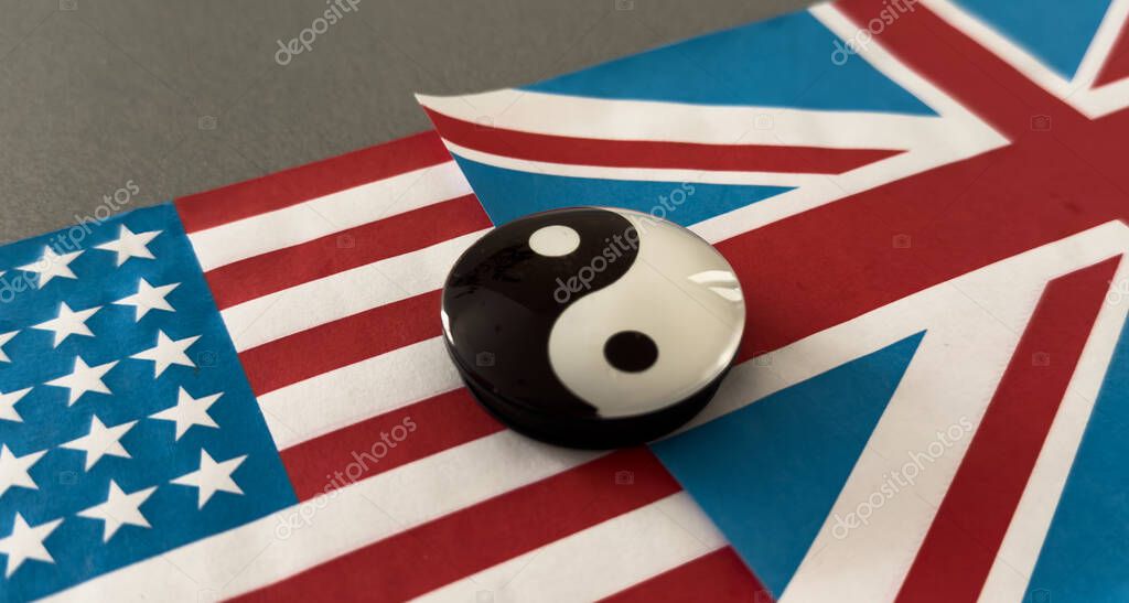 Yin and yang figurine on the background of the flags. High quality photo