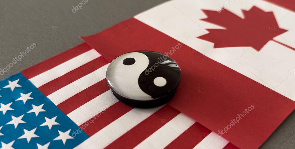 Yin and yang figurine on the background of the flags. High quality photo