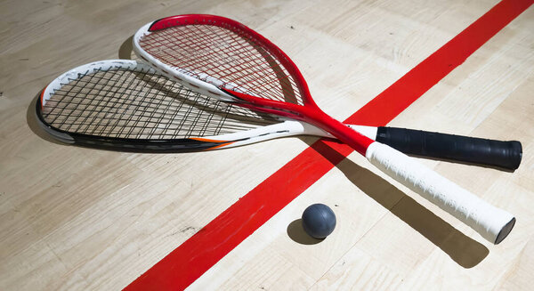 Sports, above and racket on squash court for competition, challenge and training center. Exercise, interior and empty room with top view of wooden floor of gymnasium for games, fitness club and gear. High quality photo