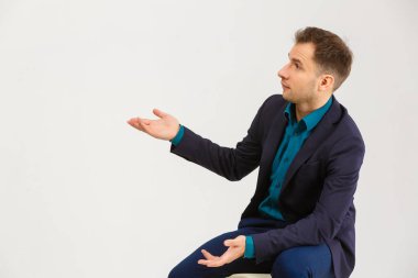 a man sits on a chair on a white background.