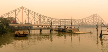 Kolkata, India, January 24, 2023: Howrah Ferry Ghat overlooking Famous Howrah Bridge at the time of Sunset.