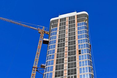 Mavi gökyüzüne karşı vinç ve inşaat yapmak