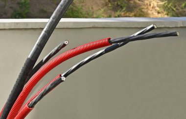 Installation of power cable in flexible PVC pipe clipart