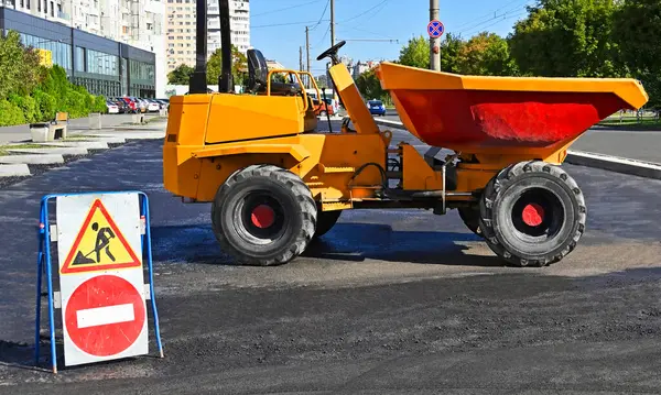 Stock image Mini dumper on roadwork and road sign