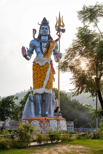 Statue of standing Lord Shiva, Hidu God at Har ki Pauri in Uttarakhand, India. Lord Shiva with trident in his hand and cobra snake around his neck.