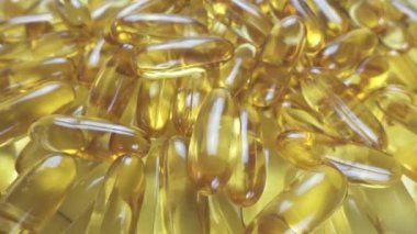 Üst görünüm, Omega 3 balık yağının yumuşak şeffaf jelatin kapsüllerinden oluşan yakın çekim dönüş yığını..