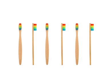 Bamboo toothbrushes with color bristles isolated on a white background with copy space
